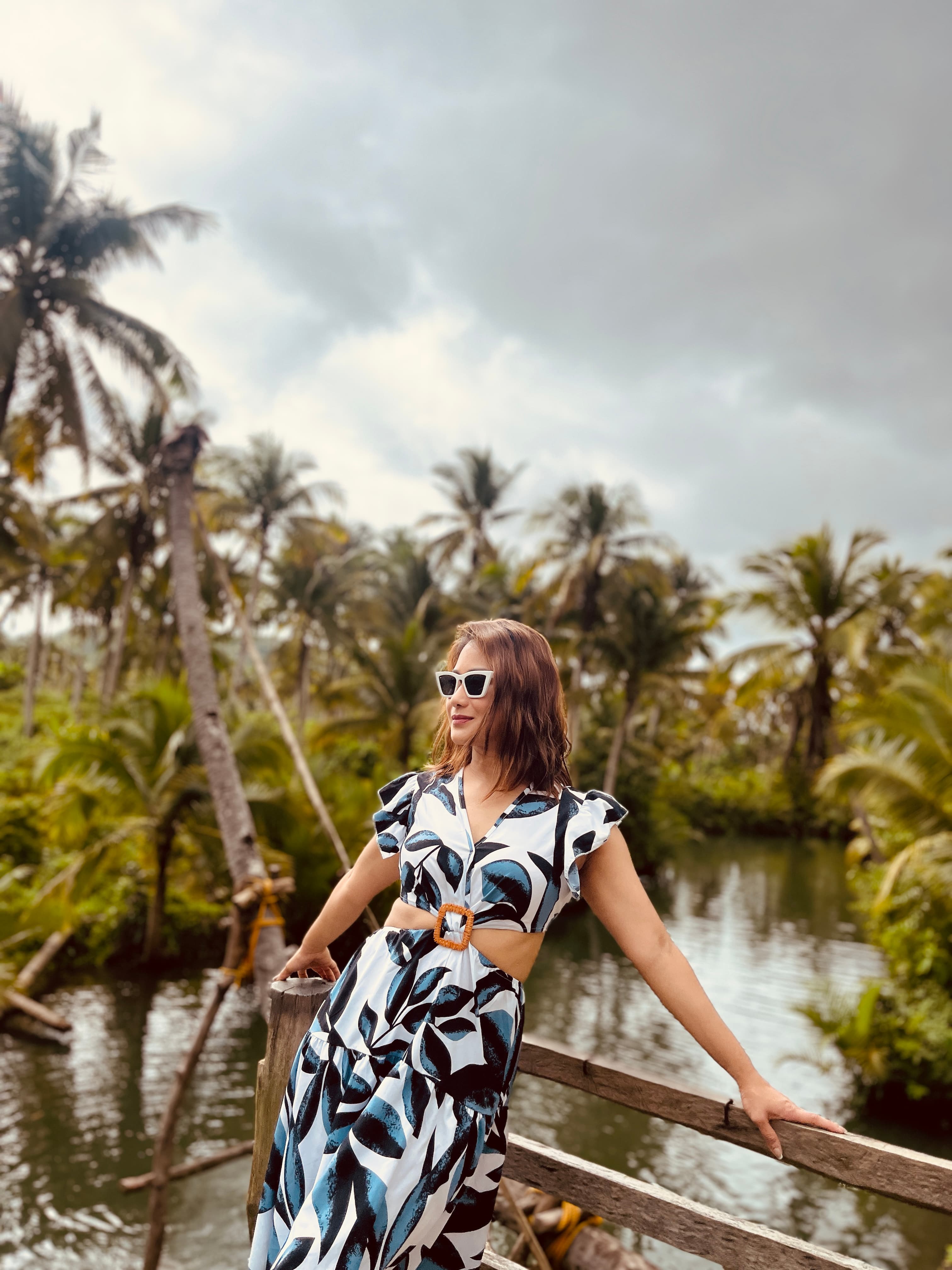 J-Ann on a wooden dock surrounded by palm trees